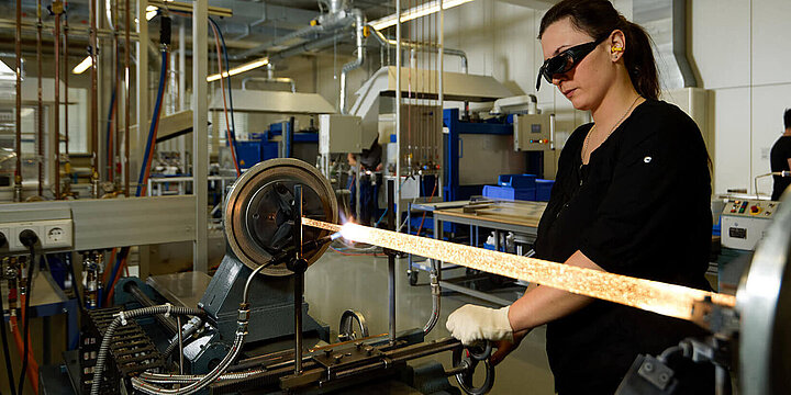 A woman in lamp production