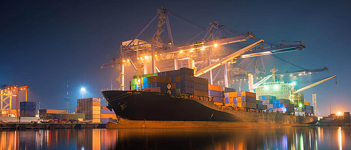Container ship in the harbor at night